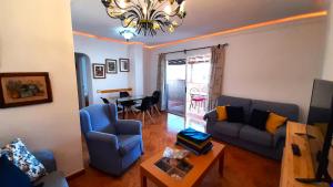 a living room with a couch and chairs and a table at Puerto Santiago Plaza in Puerto de Santiago