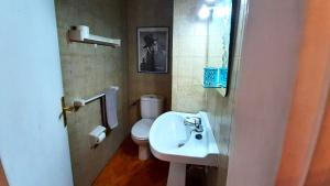 a bathroom with a white sink and a toilet at Puerto Santiago Plaza in Puerto de Santiago +17 photos