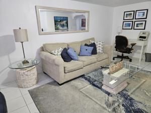 a living room with a couch and a table at Calypso Steps Away From Home in Hinson Hall