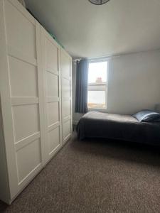 a bedroom with a bed and a window at Comfy entire place for max 4. in London