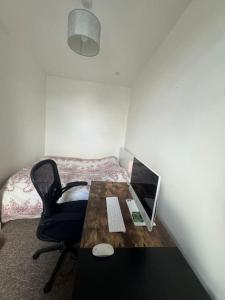 a room with a desk with a computer and a chair at Comfy entire place for max 4. in London