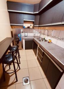 a kitchen with a counter and a sink and a table at Backpackers Oruro B&B in Oruro