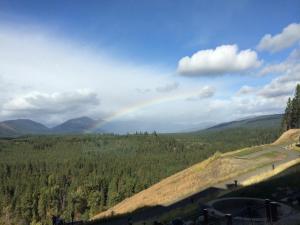 a rainbow in the sky over a hill with a road at THE BEST at SUNCADIA LODGE - EXECUTIVE RIVER VIEW SUITE in Cle Elum