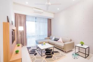 a living room with a couch and a table at Grand Medini Suites by JBcity Home in Nusajaya