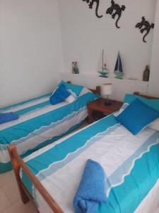 two beds in a room with blue and white at Edificio Santa Catalina in San Andrés