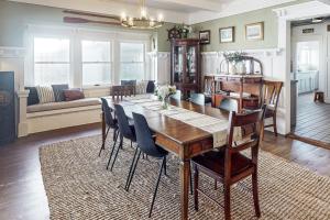 a dining table and chairs in a living room at Old Yacht Club Inn in Santa Barbara