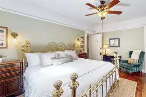 a bedroom with a white bed and a ceiling fan at Old Yacht Club Inn in Santa Barbara +21 photos