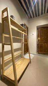 a bunk bed in a room with a ladder at Hanaia House in Stone Town
