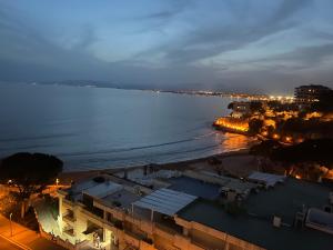 a view of the ocean at night with buildings at Blue Salou in Salou