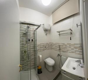 a bathroom with a shower and a toilet and a sink at 4Th Floor Caserta in Caserta +32 photos