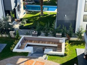 una vista aérea de un jardín con un banco en Villa Evasion D, en Seferihisar