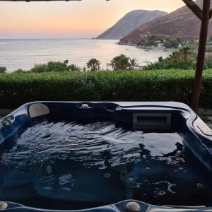 a bath tub with a view of the ocean at Alykes Studios in Grikos