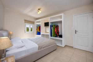 a white bedroom with a bed and a closet at George Apartment in Vóthon