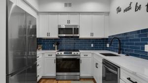 a kitchen with white cabinets and a stainless steel refrigerator at The Village Unit 616 in Santa Rosa Beach