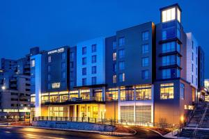 a building with lights on in a city at night at SpringHill Suites by Marriott Boston Logan Airport Revere Beach in Revere