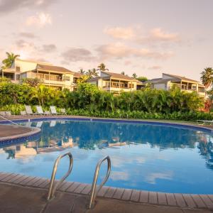 a swimming pool in front of some houses at Wailea Ekolu Village - CoralTree Residence Collection in Wailea