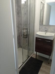 a bathroom with a shower and a sink at Aux 2 Rivières in Saint-Léger-de-Peyre