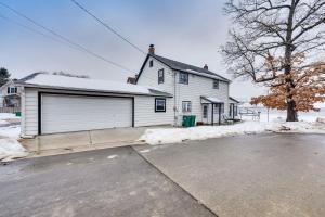 a large white house with a garage at Family-Friendly Lake Waubesa Home Boat and Swim! in McFarland