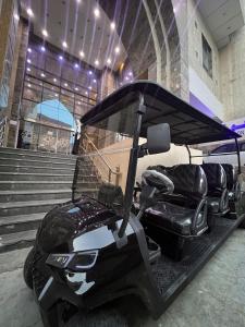 a golf cart parked in front of some stairs at Arfalon Hotel and Tourism in Makkah