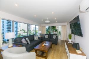 a living room with a couch and a table at Ilikai Tower 525 City View 2BR in Honolulu