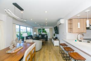 a kitchen and living room with a table and chairs at Ilikai Tower 525 City View 2BR in Honolulu