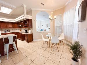a kitchen and dining room with a table and chairs at FairHaven Beach Retreat in Navarre