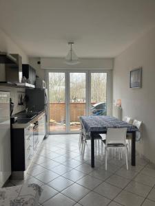a kitchen and dining room with a table and chairs at La Stella Blu in Gatteo a Mare