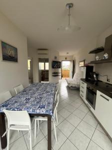 a kitchen and dining room with a table and chairs at La Stella Blu in Gatteo a Mare +4 photos