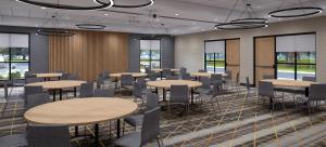 a dining room with tables and chairs and windows at Holiday Inn Corpus Christi Arpt & Conf Ctr, an IHG Hotel in Corpus Christi