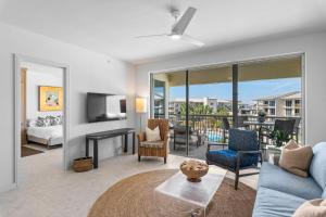 a living room with a couch and a tv at High Pointe Resort 414 in Rosemary Beach