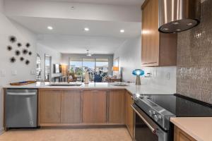a kitchen with wooden cabinets and a stove top oven at High Pointe Resort 414 in Rosemary Beach