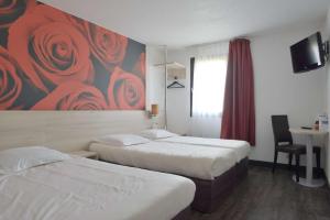 a hotel room with two beds and a painting of roses at Brit Hotel Essentiel de Granville in Granville