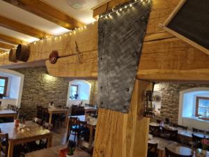 a large wooden wall in a restaurant with tables at Babyhotel Karolínka, wellness in Vranov nad Dyjí