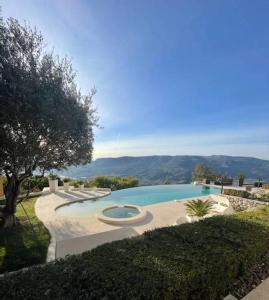 a swimming pool with a view of the mountains at Maison de 4 chambres avec piscine privee jacuzzi et jardin clos a Aspremont in Aspremont