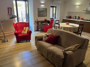 a living room with a couch and chairs and a table at Home in Orvieto - Corso Cavour in Orvieto