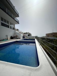 a swimming pool on the side of a building at Apartamento Verdial 2 in Cala del Moral