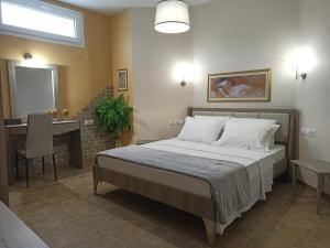 a bedroom with a bed and a table and a mirror at Zeusplace Olympous Riviera Villa 1 in Litochoro