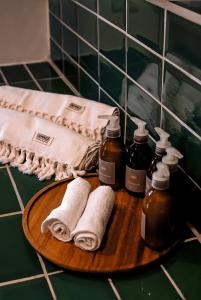 a bathroom counter with towels and bottles of soap at Casa Akaw in Temalhuacán
