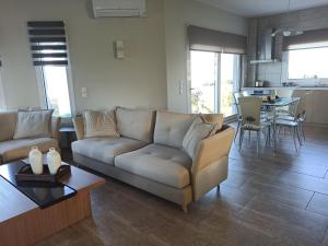 a living room with a couch and a table at Zeusplace Olympus Riviera Villa 1 in Litochoro