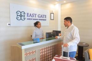 a man and a woman standing at a cash register at East Gate Appartement Gust House in Addis Ababa