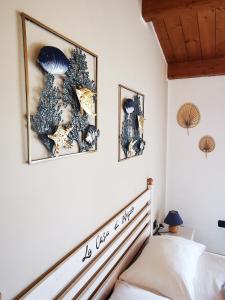 a bedroom with two pictures of mushrooms on the wall at La Casa Di Angelo in Tresnuraghes