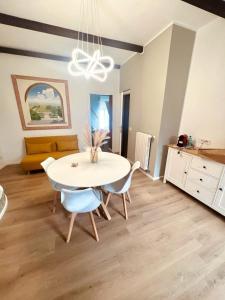 a dining room with a white table and chairs at Casa gioia in Bracciano