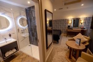 a bathroom with a shower and a sink and a desk at Brisbane House Hotel in Largs