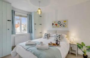 a bedroom with a bed with two towels on it at Cosy and Fresh Seaside Home - Parking in Sheringham