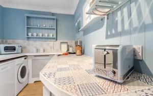 a kitchen with a counter with a toaster on it at Cosy and Fresh Seaside Home - Parking in Sheringham