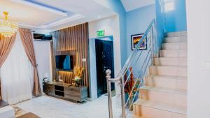 a staircase in a home with blue walls and a stair case at 2 bedroom Greys apartment Gwarimpa in Gwarinpa