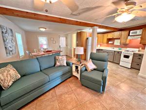 a living room with a couch and chairs and a kitchen at Porpoise Pass in Foley