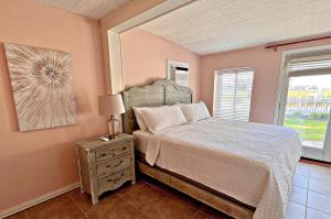 a bedroom with a bed and a dresser and a window at Porpoise Pass in Foley