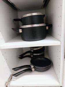 a shelf with two pans and a top hat at L8 Street - Leipziger Straße in Kaiserslautern