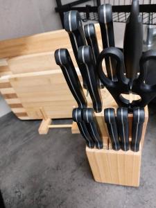 a bunch of knives in a wooden holder at L8 Street - Leipziger Straße in Kaiserslautern